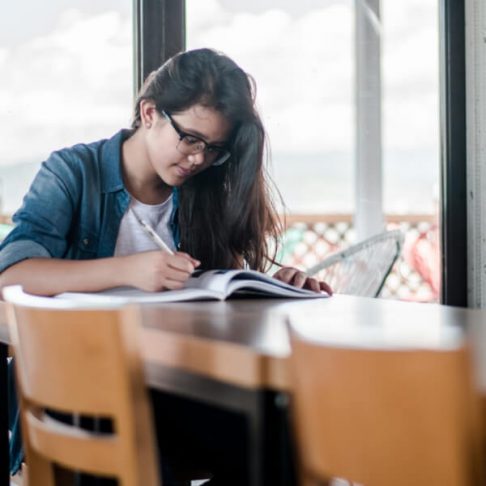 student writing in a book