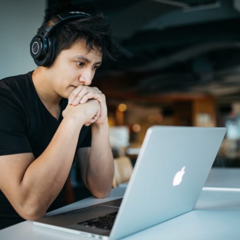 student looking at a macbook