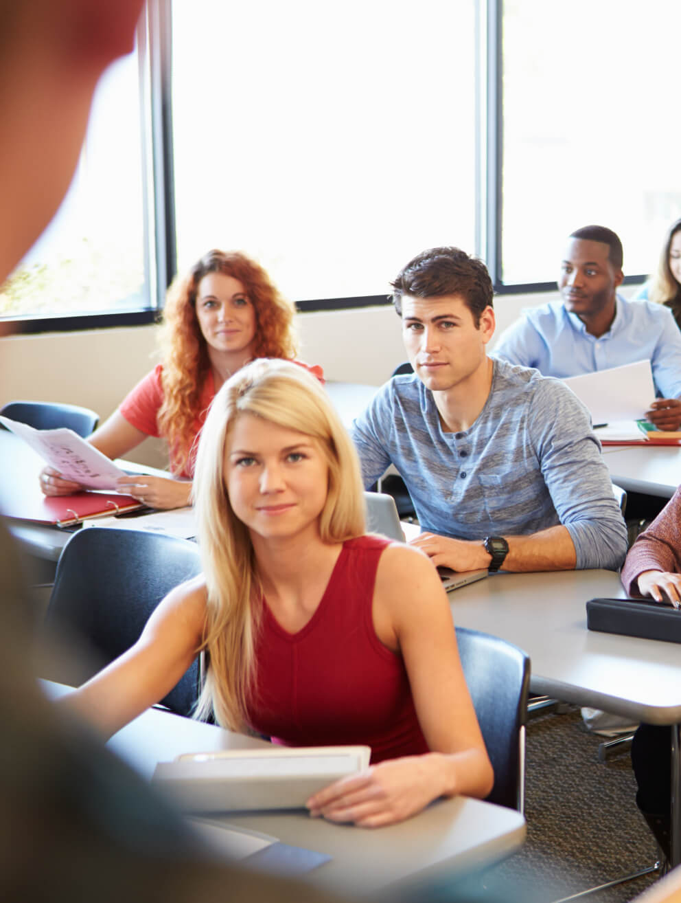 students in a classroom listing to a teacher